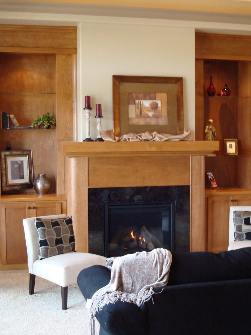Lit fire with wood surround and mantel
