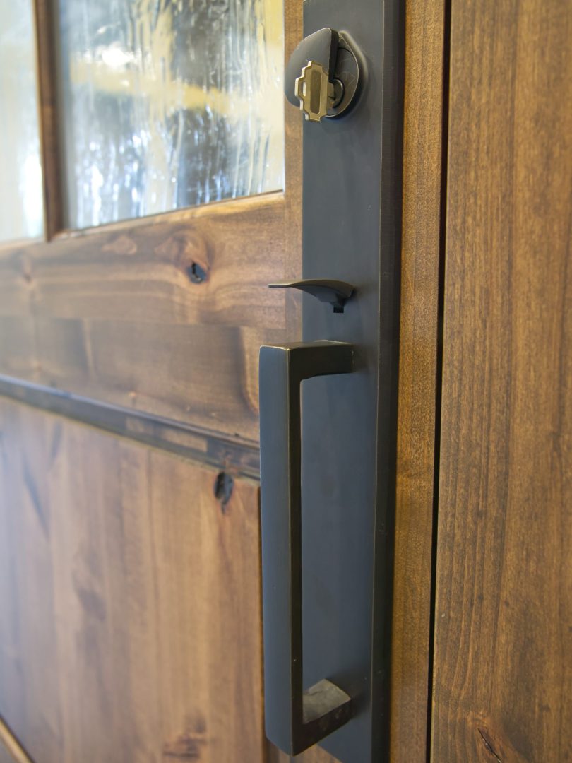 Front door hardware on natural wood door