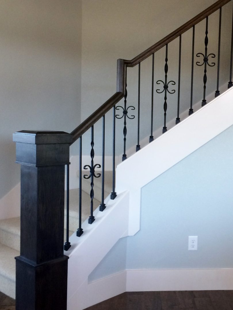 Stairway with black newel post and balusters